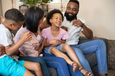 Loving african american family enjoying quality time at home