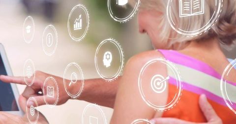 Senior couple exploring tablet with augmented reality icons and touchscreen guidance