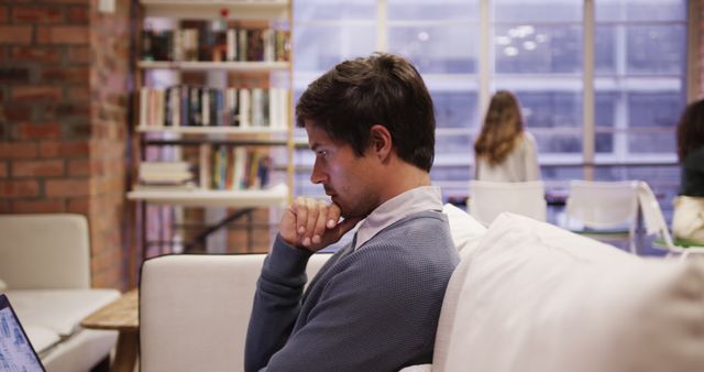 Young Man Focused on Laptop in Cozy Loft Apartment - Download Free Stock Images Pikwizard.com