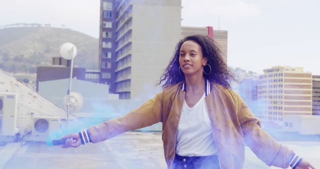 Youthful Woman Celebrating with Smoke Bomb on City Rooftop - Download Free Stock Images Pikwizard.com