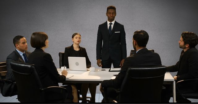 Confident Businessman Leading Meeting with Team - Download Free Stock Images Pikwizard.com