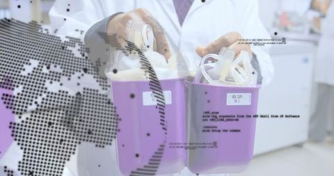 Researcher holding purple specimen bins with clear tubing in clinical laboratory