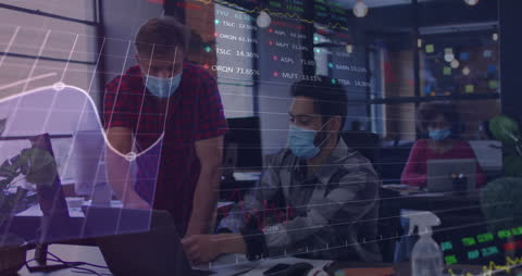 Office Workers Analyzing Data with Safety Precautions During Pandemic