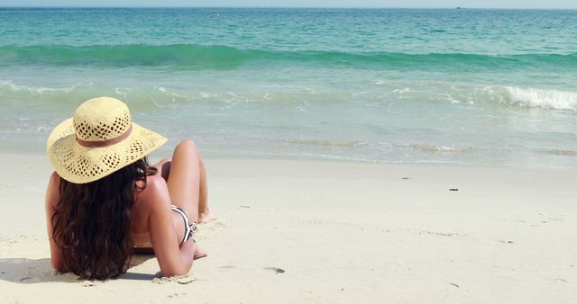 Woman Relaxing on Beach with Straw Hat Facing Ocean - Download Free Stock Images Pikwizard.com