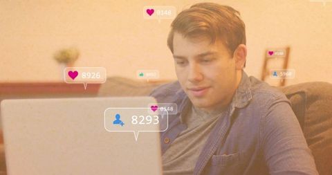 Man Engaging with Social Media on Laptop in Cozy Living Room