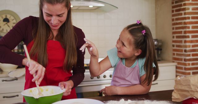 Mother and daughter bonding together baking in kitchen - Download Free Stock Images Pikwizard.com