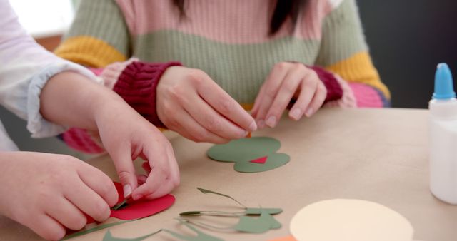 Close-up of People Engaging in Crafting Activity with Colorful Paper - Download Free Stock Images Pikwizard.com