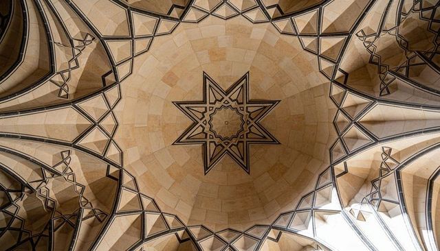 Ornate mosque dome, eight-pointed star, geometric rib vaulting, clerestory