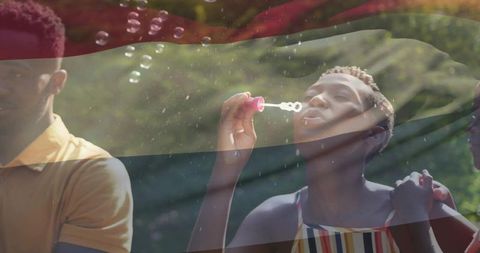 Joyful Woman Blowing Bubbles in Sunlit Garden
