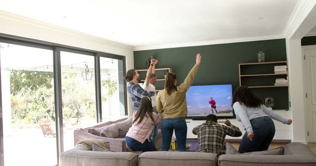 Friends cheering and celebrating while watching sports on TV - Download Free Stock Images Pikwizard.com