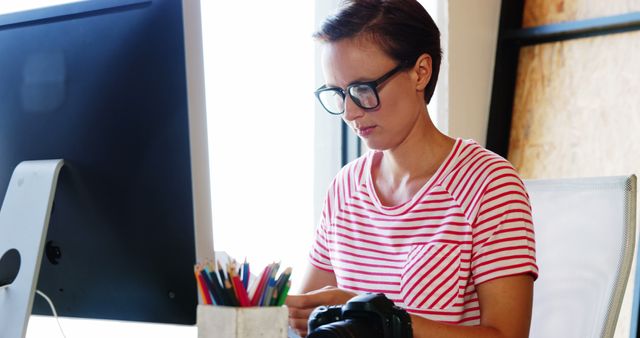 Creative Professional with Digital Camera Working at Desk - Download Free Stock Images Pikwizard.com