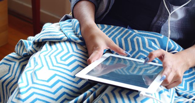 Person Relaxing with Tablet and Earphones in Cozy Blanket - Download Free Stock Images Pikwizard.com