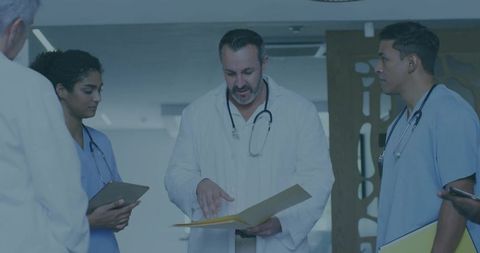 Multiracial Medical Team Collaborating in Hospital Hallway