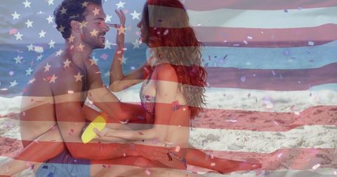 American Flag Overlay on Joyful Couple Relaxing at Beach