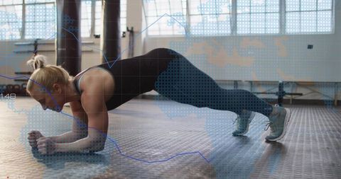 Holding forearm plank in gym showing fitness data overlay and core strength training focus