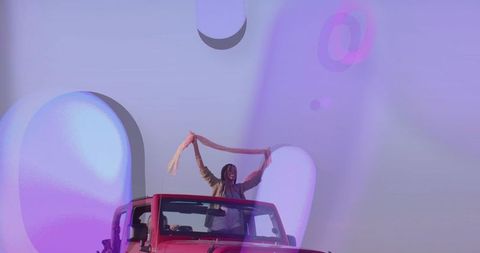 Joyful Road Trip in Red Convertible with Stylish Friends