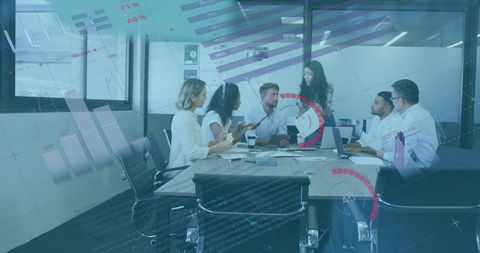 Diverse Team Collaborating with Superimposed Statistics in Modern Office