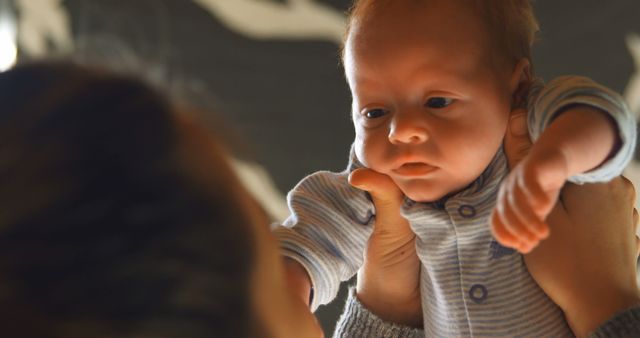 Mother Holding Baby Face to Face Interaction Indoors - Download Free Stock Images Pikwizard.com