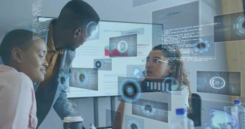 Team collaborating at ar workstations analyzing code and data visualizations in office