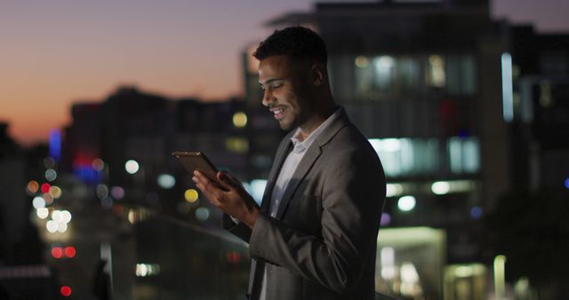 Young Businessman Using Digital Tablet at Night in Urban Setting - Download Free Stock Images Pikwizard.com