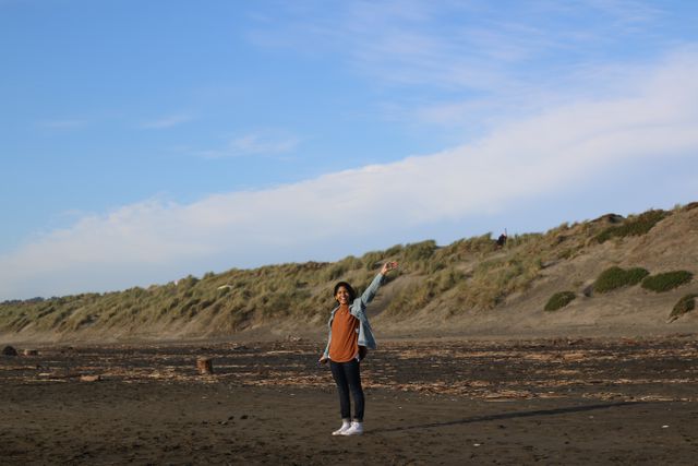 Young Person Posing at Sandy Beach - Download Free Stock Images Pikwizard.com