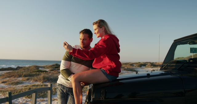 Couple Enjoying Sunset by the Beach with Smartphone - Download Free Stock Images Pikwizard.com