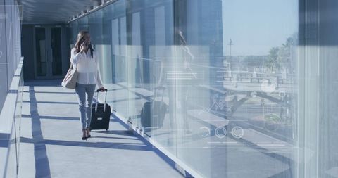 Businesswoman with Suitcase Talking on Phone at Airport - Download Free Stock Images Pikwizard.com