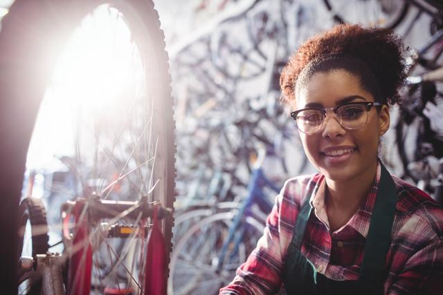 Useful for content related to women in trades, bicycle repair tutorials, small business promotion, and workshop environments. Highlights skilled labor and expertise in bicycle maintenance.
