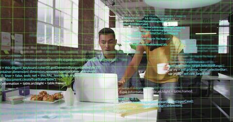 Woman guiding colleague over laptop while collaborating on code in bright brick office