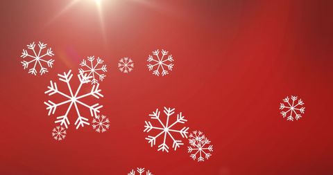 Festive snowflakes on red background celebrating holiday spirit