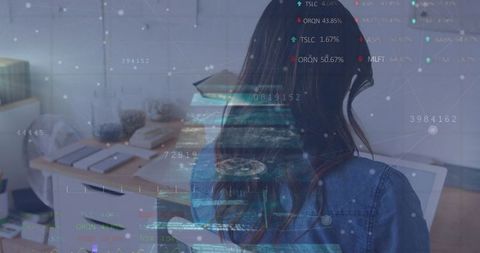 Businesswoman Engaging with Futuristic Data Display in Office