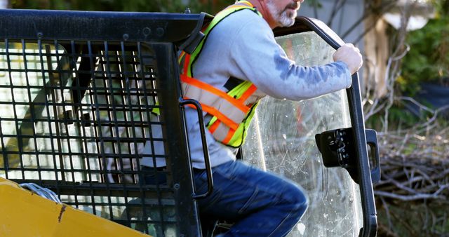 Construction Worker Operating Heavy Machinery Wearing Safety Gear - Download Free Stock Images Pikwizard.com