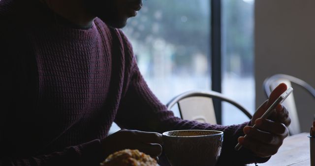 Man Drinking Coffee and Checking Smartphone in Cafe - Download Free Stock Images Pikwizard.com