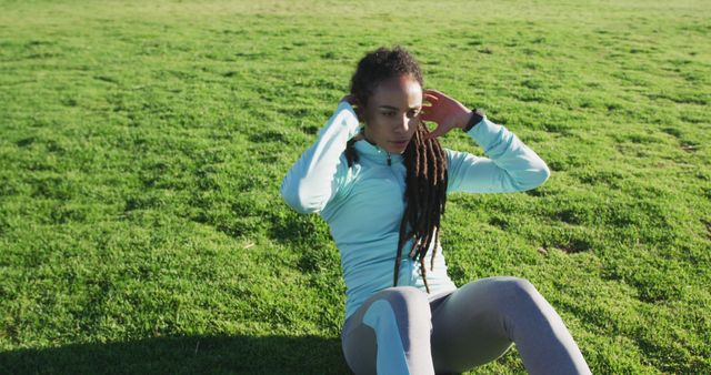 Focused Woman Doing Outdoor Sit-ups in Green Park - Download Free Stock Images Pikwizard.com