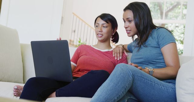 Two Women Friends Browsing Laptop Together on Couch - Download Free Stock Images Pikwizard.com