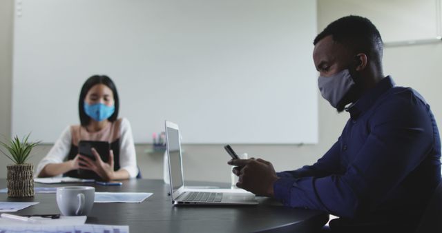 Multiracial Colleagues Working on Laptops Using Smartphones in Office Wearing Face Masks - Download Free Stock Images Pikwizard.com