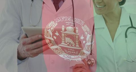 Smiling Medical Professionals in White Coats with Afghanistan Flag Overlay
