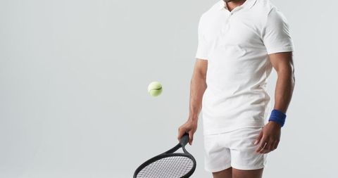 Dynamic Tennis Player in Mid-Action With Tennis Ball and Racket