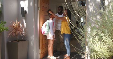 Family Welcoming Daughter Home with Warm Hugs and Smiles