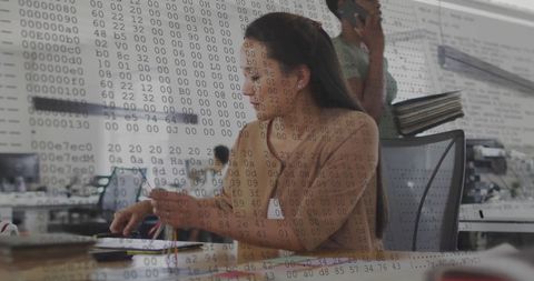 Biracial businesswoman analyzing data in high-tech office environment