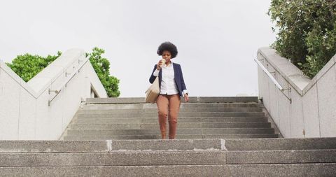 Confident African American Businesswoman Walking Down City Steps