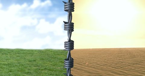 barbed wire dividing green and desert landscapes - Download Free Stock Images Pikwizard.com