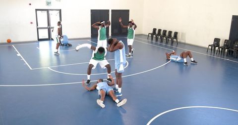 Basketball Training Session with Diverse Team in Gymnasium