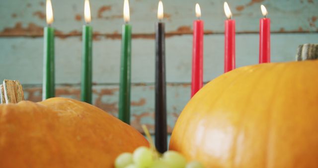 Kwanzaa Kinara with Lit Candles and Pumpkins in Background - Download Free Stock Images Pikwizard.com