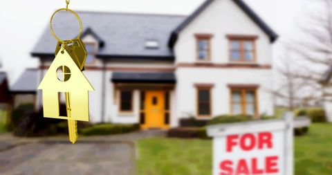 Golden key to new home ownership with for sale sign