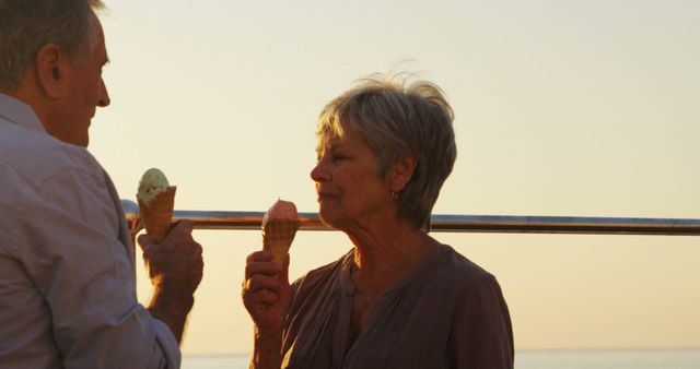 Happy Senior Couple Eating Ice Cream at Sunset Beach - Download Free Stock Images Pikwizard.com