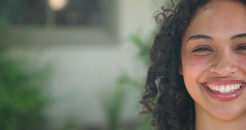 Joyful Woman with Curly Hair Sunshine Smile