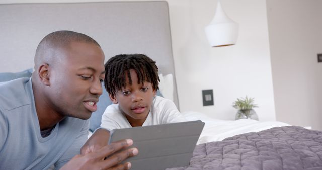 Father and Son Bonding over Digital Tablet at Home - Download Free Stock Images Pikwizard.com