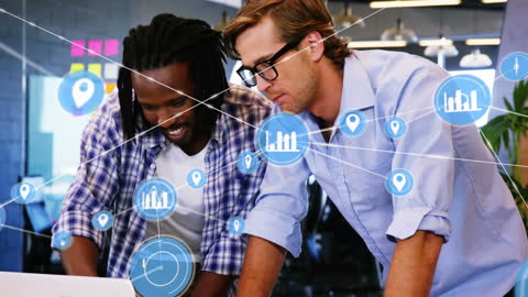 Diverse Colleagues Discussing Digital Network in Office Workspace