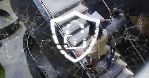 Business professionals riding escalator with digital shield overlay for cybersecurity
